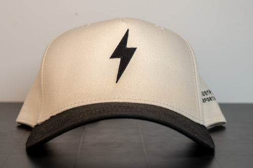 cream cap with black brim and a single black lightning bolt embroidered on the front