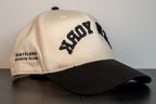 alt: side view of the new york cap with hustlers sports club embroidered on the panel