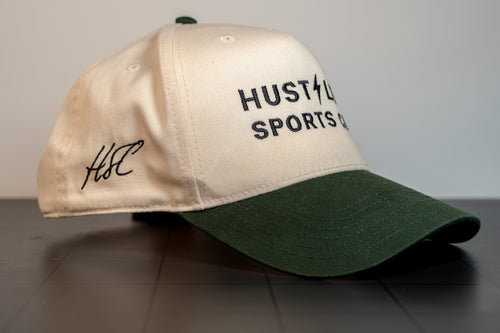 side view of the cream and green hustlers sports club cap showing the bolt mark and structured crown